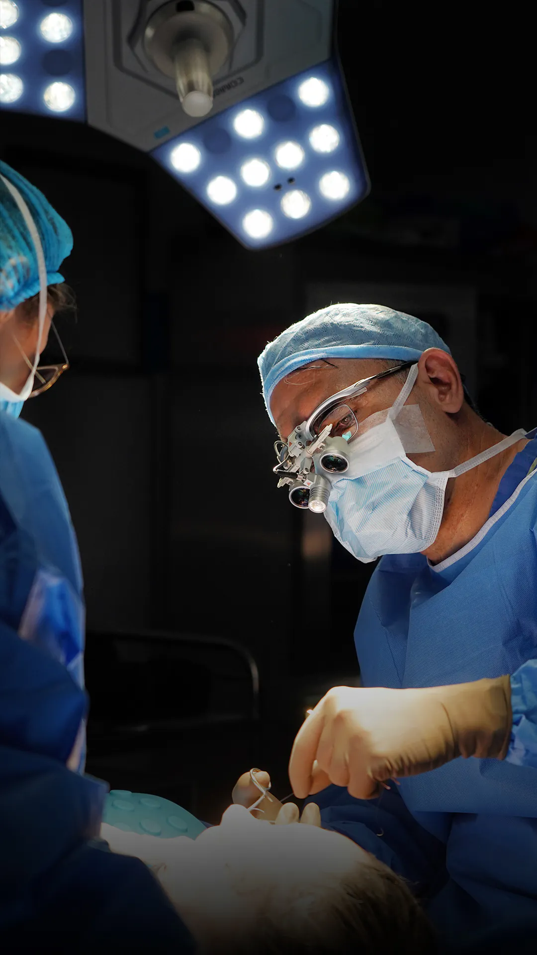 Dr. Teoman Dogan and an assistant surgeon during a nasal procedure