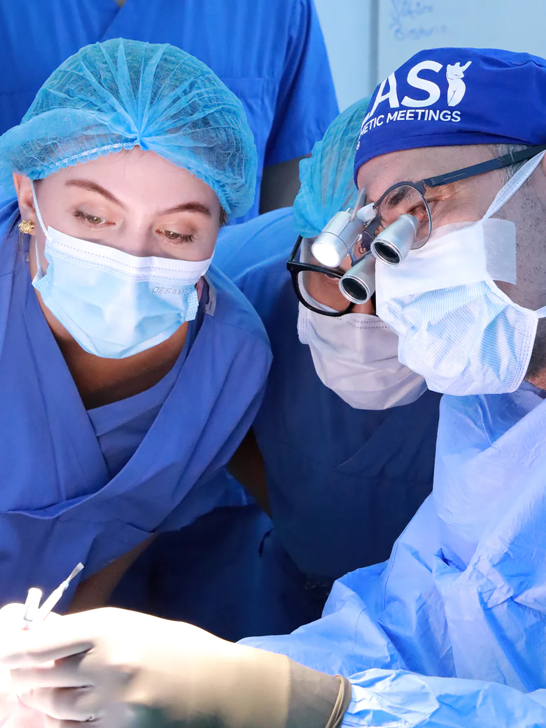 Dr. Teoman Dogan demonstrating a surgical step to an observing surgeon