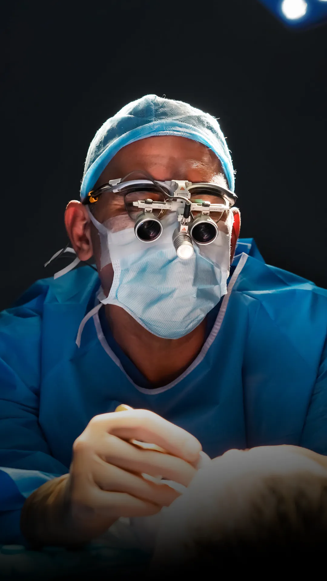 Dr. Teoman Dogan wearing surgical loupes in the operating room