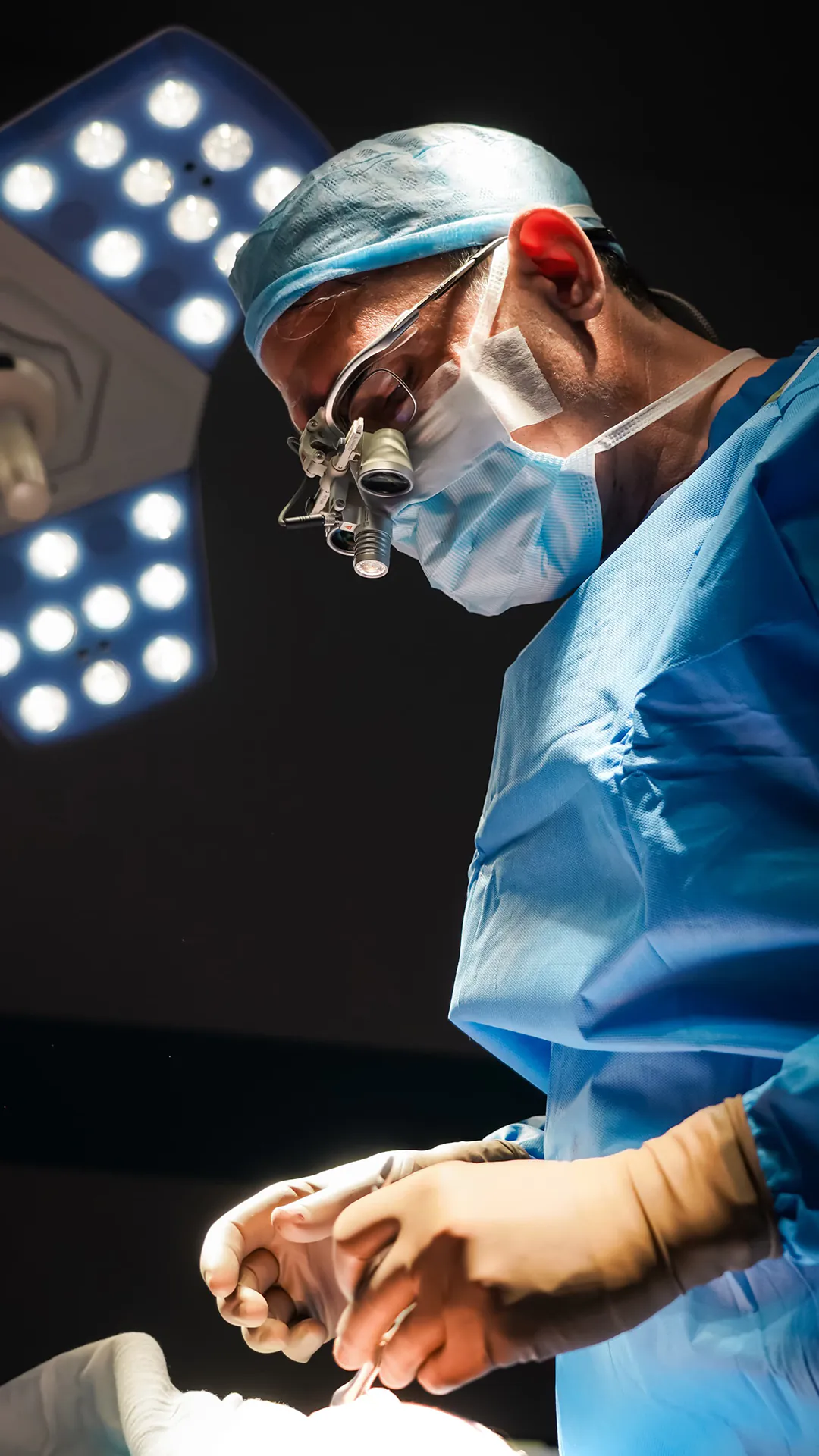 Dr. Teoman Dogan operating under surgical loupes